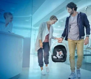 Mum and dad carrying baby in maxi cosi capsule